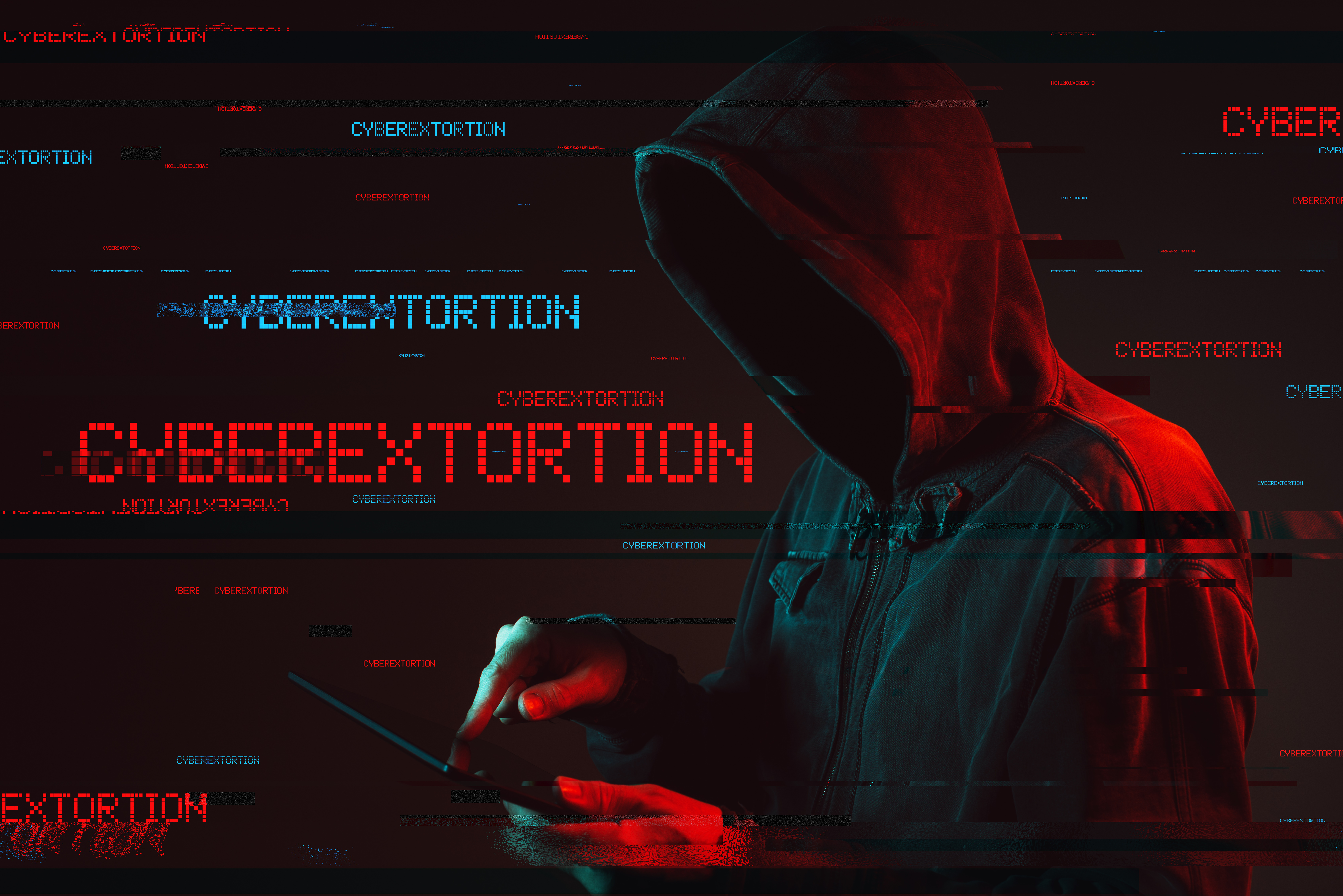 Faceless cybercriminal using a tablet in red and blue light