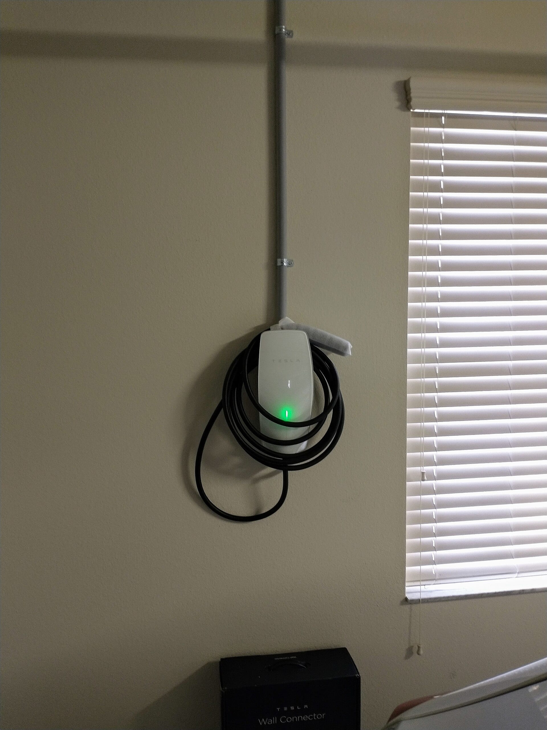 A real Tesla Wall Connector installed in a home garage